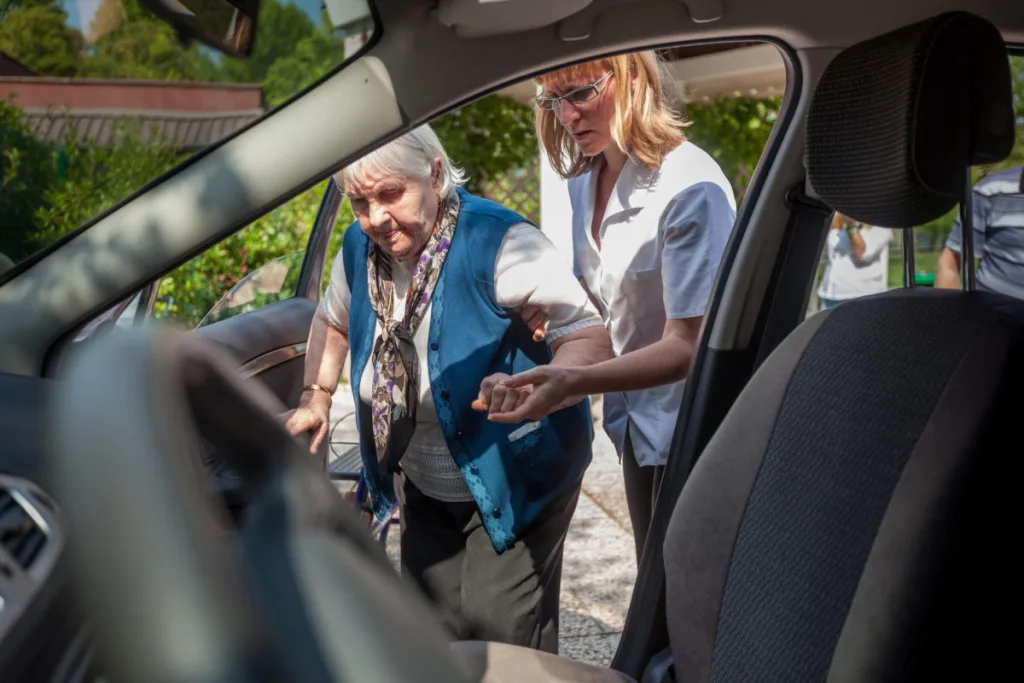 Stallio Outsourcing Comprehensive outsourcing solutions. Personal Assistent Helping To Senior Woman Into Car
